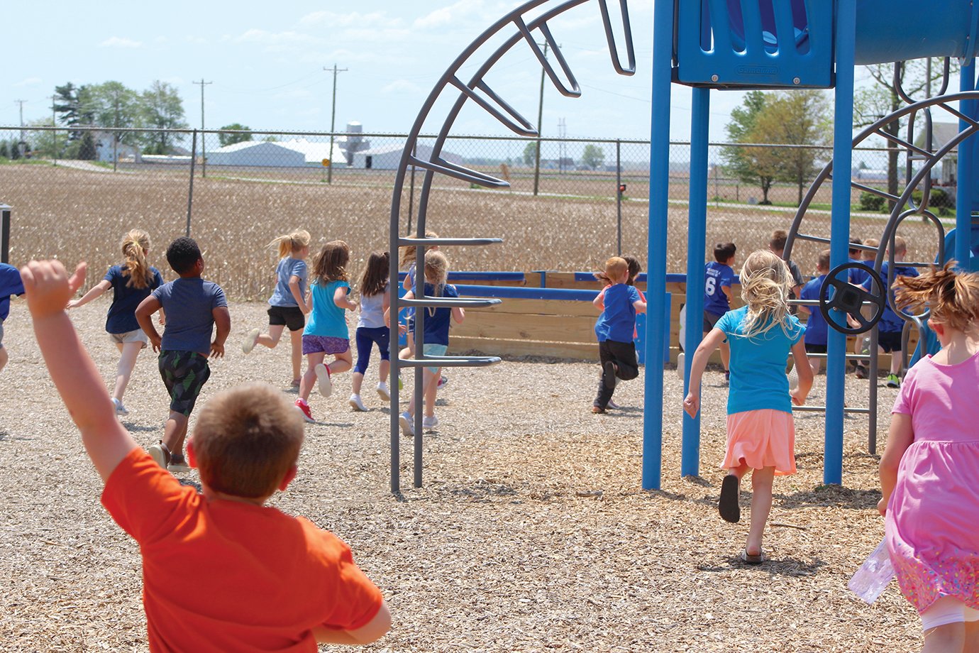 Walnut Elementary students flock to a playground expansion in the school’s recess area Friday following a dedication ceremony for Parker’s Place, named for late Walnut Flyer Parker Schroll.